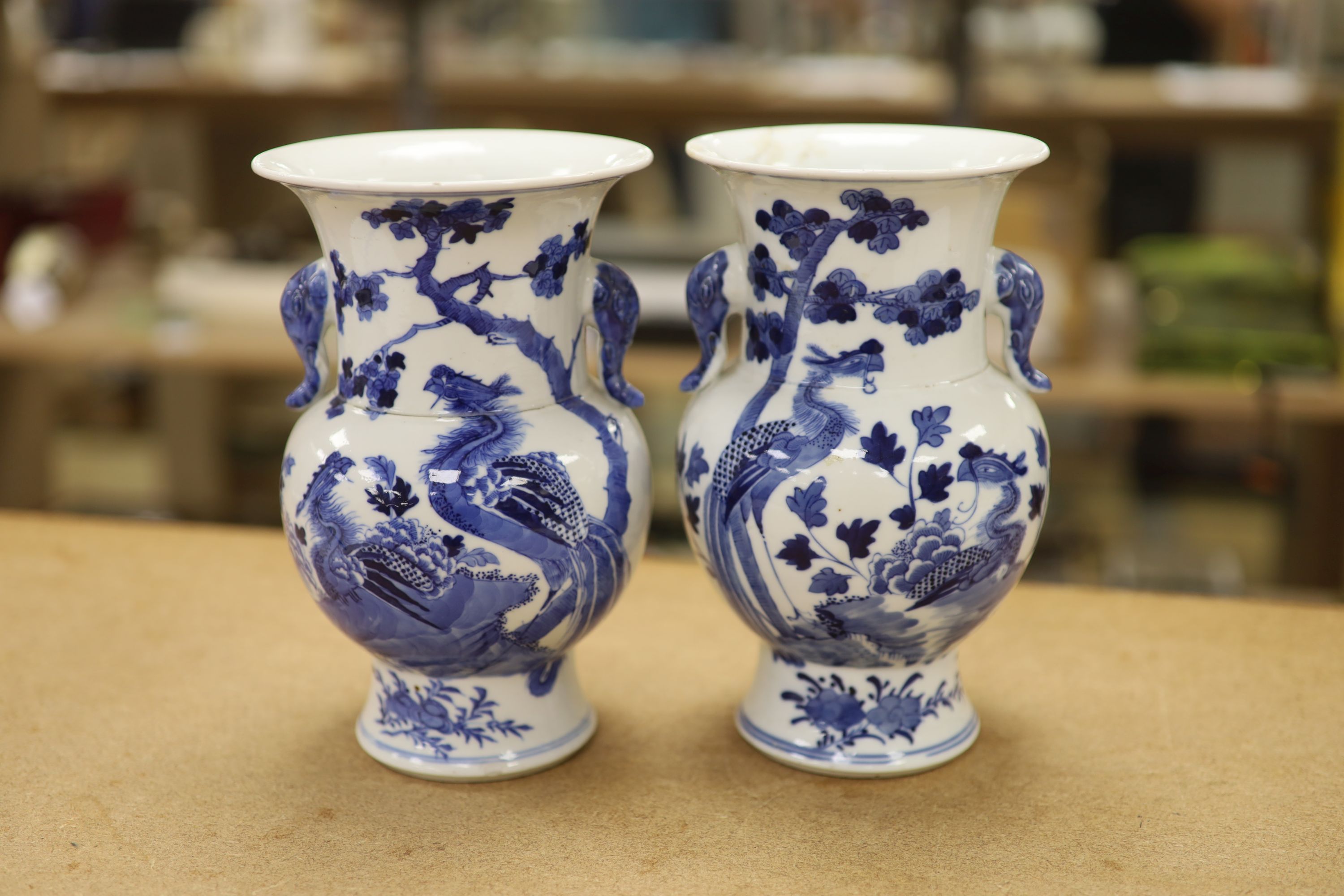 A pair of Chinese blue and white 'phoenix' vases, Kangxi marks but late 19th century, height 20cm (a.f.)
